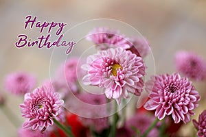 Birthday card and greeting concept. With text message - Happy Birthday. On background of close up pink flowers bouquet.