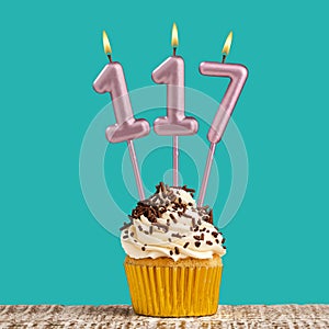 Birthday card with number 117 candle on aquamarine background