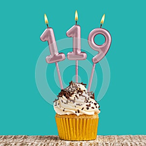 Birthday card with number 119 candle on aquamarine background