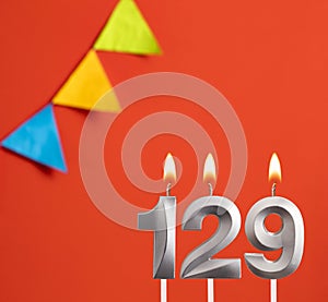 Birthday card - Number 129 candle in orange background