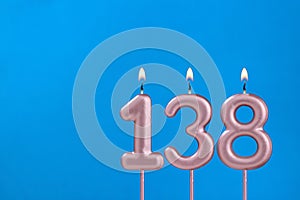 Birthday card with number 138 - Burning anniversary candle on blue background