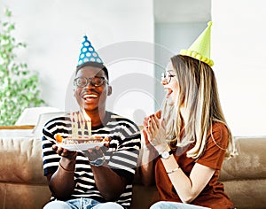 birthday celebration party cake happy candle blowing friendship fun friend woman home smiling lifestyle happy man