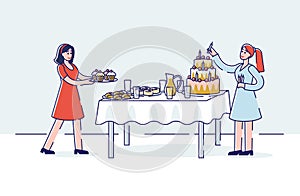 Birthday celebration preparation with two women serving holiday sweet table - big cake and cupcakes