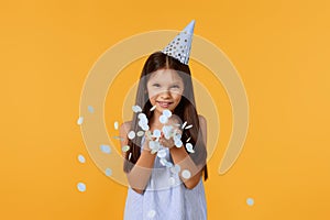 birthday child girl blowing confetti off her hands