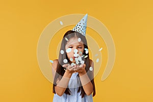 birthday child girl blowing confetti off her hands