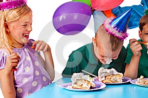 Birthday children celebrate party and eating cake on plate together .