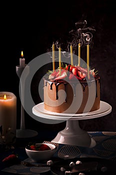 Birthday chocolate cake with candles. Blow out candles on top of a cake