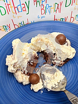 Birthday chocolate cream dessert on a blue plate.