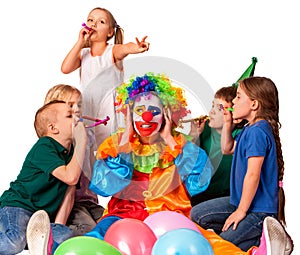 Birthday clown close ears of children`s noise with group children.