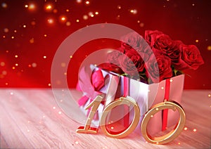 Birthday concept with red roses in gift on wooden desk. hundredth. 100th. 3D render