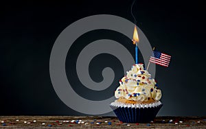 Birthday cupcake. American Flag. Burning candle light in a cake. 4th of July, Independence, Memorial or Presidents Day.