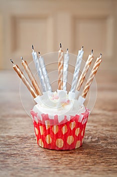 Birthday cupcake blurry background with lots of lit candles