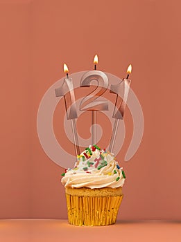 Birthday cupcake with candle number 121 - Coral fusion background