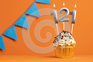 Birthday cupcake with candle number 121 - Orange background