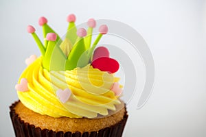 Birthday cupcake in front of a white background Cupcake with yellow cream