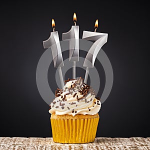 birthday cupcake with number 117 candle - Celebration on dark background