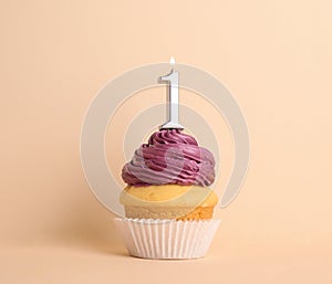 Birthday cupcake with number one candle on background