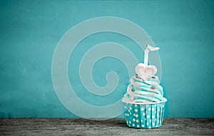 Birthday cupcake with sweet heart shape of marshmallow