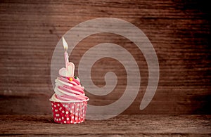 Birthday cupcake with sweet heart shape of marshmallow