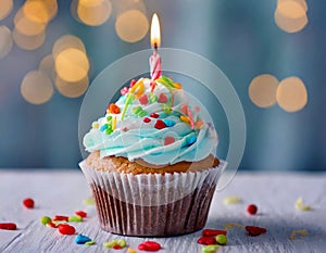 birthday cupcake on table on light blue background