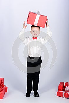 Birthday gift. Small boy hold gift box. Christmas or birthday gift. Dreams come true. Buy gifts. Happiness and positive