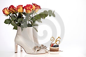 Birthday greeting card with cake women's boots and roses on white background