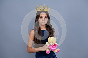 Birthday kids prom party. Little queen wearing golden crown. Teenage girl princess holding crown tiara. Prom party