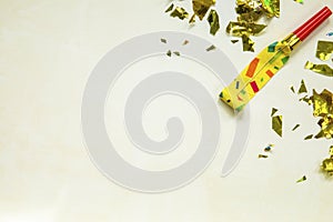 Birthday party blowouts whistles Rolled festive noisemaker or party whistle on concrete light background, blowing in