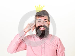 Birthday party of cheerful bearded man, celebration concept. Happy man with long beard and big smile holding paper crown