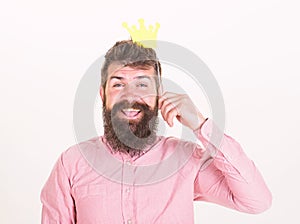 Birthday party of cheerful bearded man, celebration concept. Happy man with long beard and big smile holding paper crown