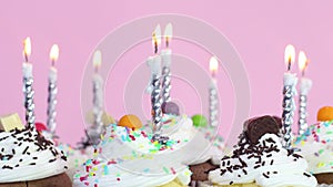 Birthday party cup cakes with cream and burning candles
