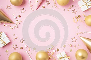 Birthday party festive background with golden decoration from gift box, balloons, carnival hat, confetti on pastel pink table