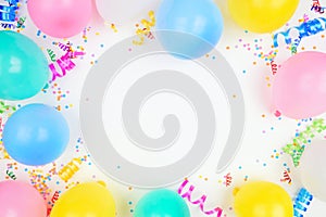 Birthday party frame on a white background view with balloons, confetti and streamers