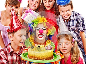 Birthday party group of child with cake.