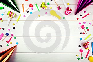 birthday party items and decorations on white wood background