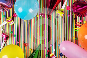 birthday party items on striped background with copy space