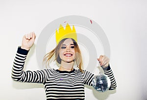 Birthday party, new year carnival. Young smiling woman on white background celebrating brightful event, wears stripped