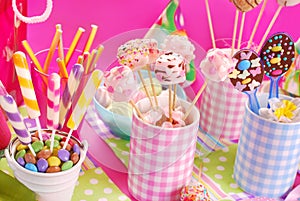 Birthday party table with marshmallow pops and other sweets for