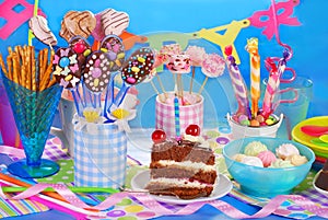Birthday party table with torte and sweets for kids photo