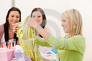 Birthday party - woman unwrap present, surprise