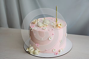 Birthday pink cake with one candle