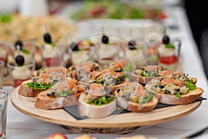 Birthday Table With Food. Snacks and Appetizer on the Table. Fish and Raw Meat with Vegetables.