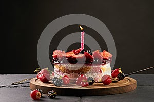 Birthday tart on dark stone table