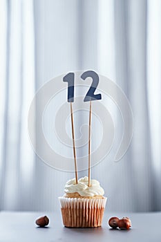 Birthday vanilla cupcake with number 12 twelve