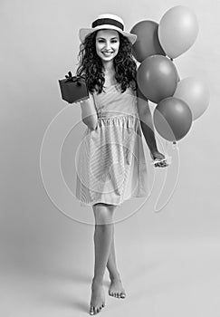 birthday woman with gift balloons isolated on yellow. birthday woman with gift balloons in studio. birthday woman with