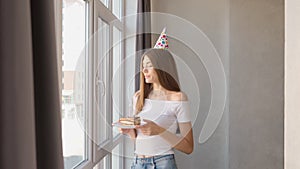 birthday woman making wish and blowing candle on cake.