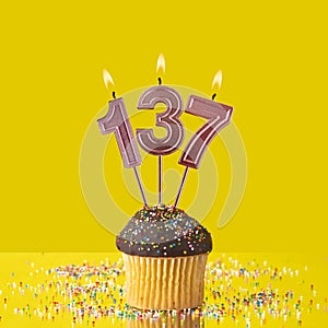 Birthday on a yellow background - Number 137 candle
