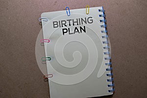 Birthing Plan write on Book. Isolated on office desk background