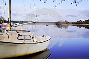 Biscarrosse harbor in lake with small boat sailboat in blue water reflection in landes france photo