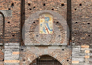 Biscione above the Porta Del Barcho entrance Sforza Castle  in Milan, Italy